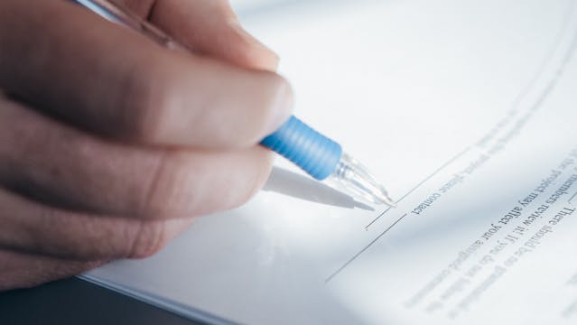 person signing a document